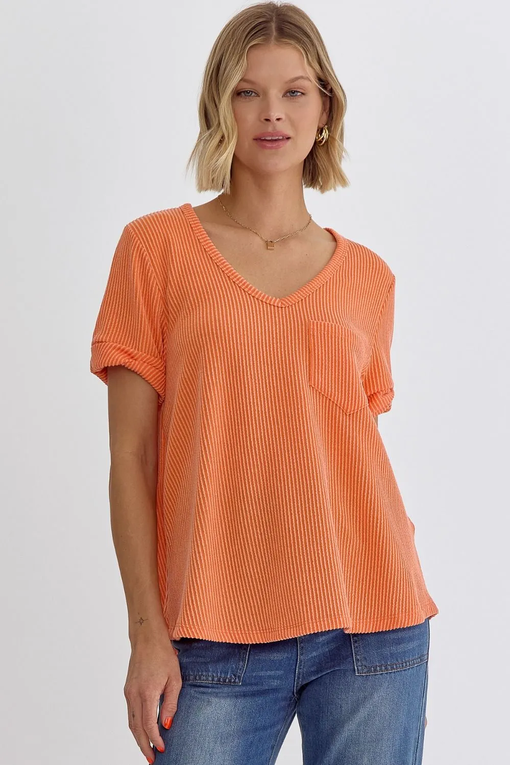 Erica V-neck short sleeve top featuring rolled sleeve hem and pocket at bust In Orange