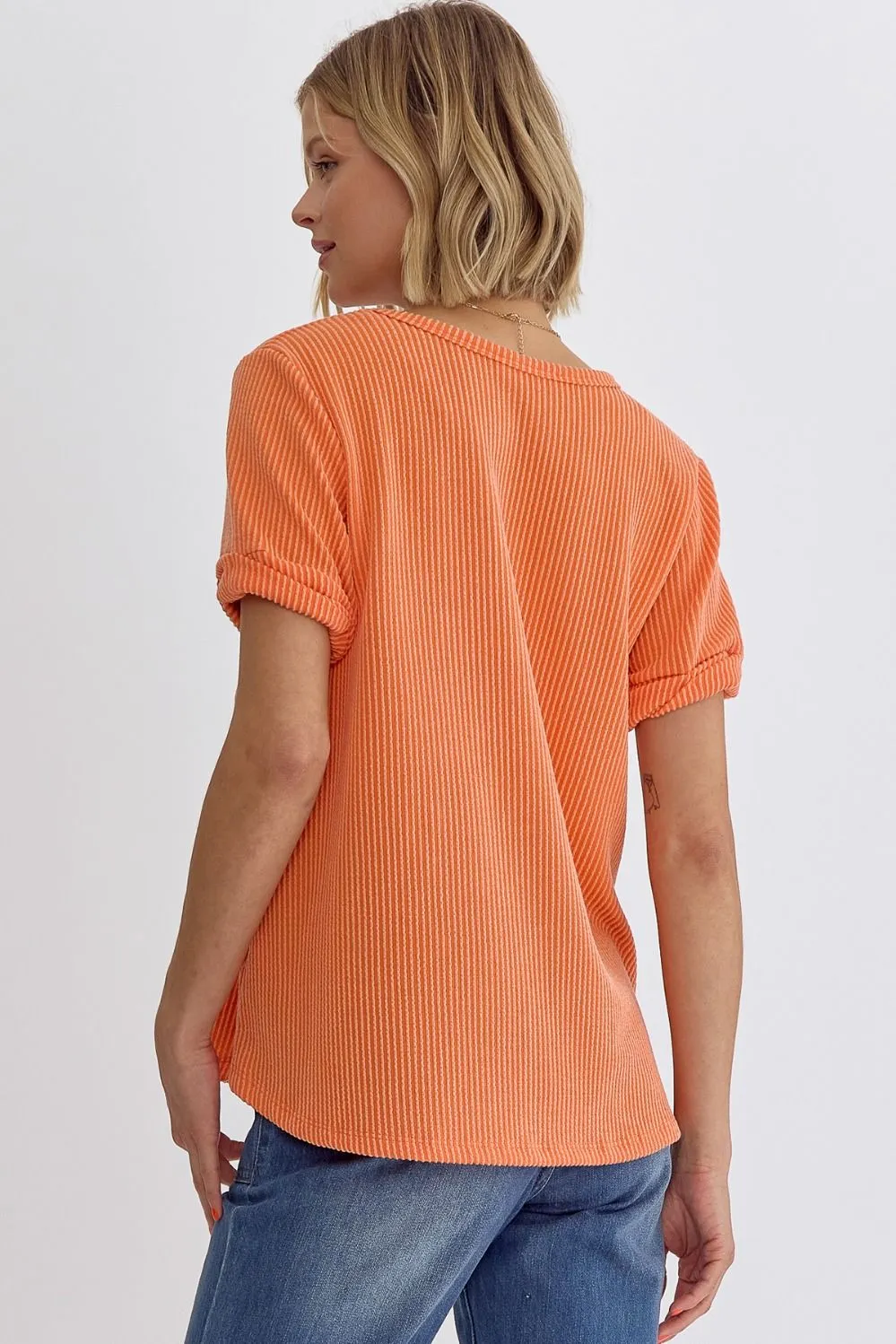 Erica V-neck short sleeve top featuring rolled sleeve hem and pocket at bust In Orange